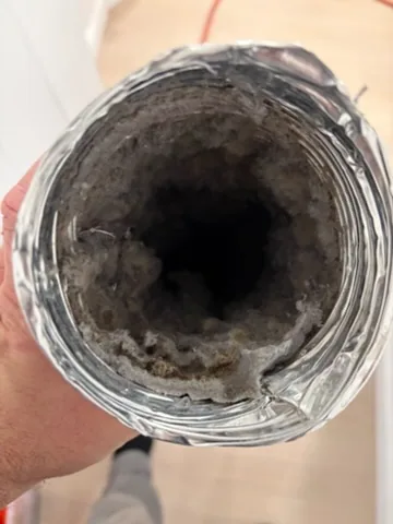 Lint lining the end of a flex duct, Center Moriches, NY
