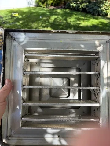 A removed square register held outdoors, East Moriches, NY